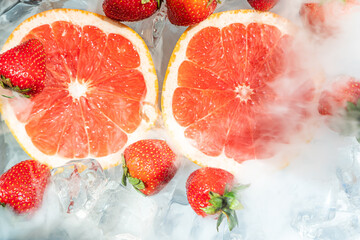 Grapefruit with strawberry in ice cube water