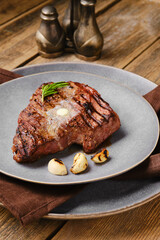 Closeup view of beef steak with a piece of butter