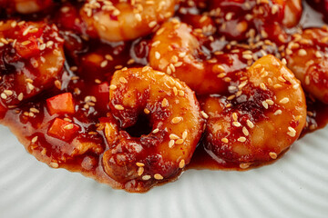 Shrimp with sweet sauce and sesame seeds dish on a wooden background