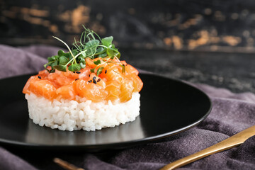 Delicious salmon tartar on dark background, closeup