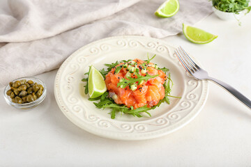 Delicious salmon tartar on light background