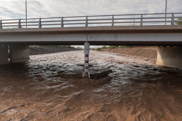 Rising river water after heavy rainfall. Measurements on bridge.
