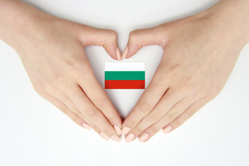 Women's hands create a heart inside the flag of Bulgaria on a white background.Background for...