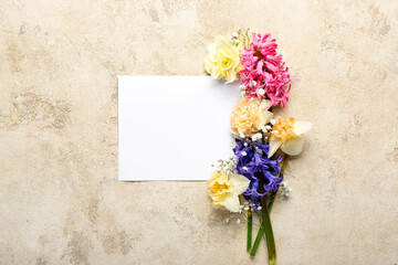 Beautiful flowers and blank sheet of paper on grunge background