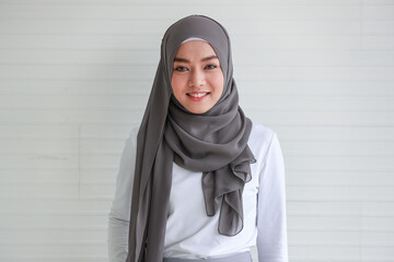 Portrait of cout beautiful Muslim woman wearing hijab traditional religious cloth posing with friendly looking to camera with a lovely smile on white background - obrazy, fototapety, plakaty