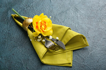 Beautiful table setting with narcissus flower on dark background