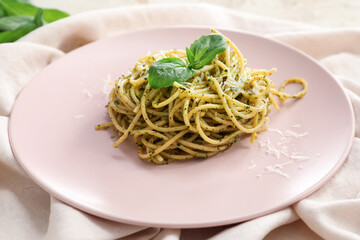 Plate with tasty pesto pasta on table
