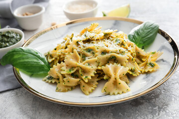 Plate with tasty pesto pasta on table