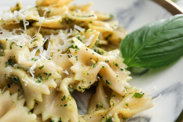 Plate with tasty pesto pasta, closeup