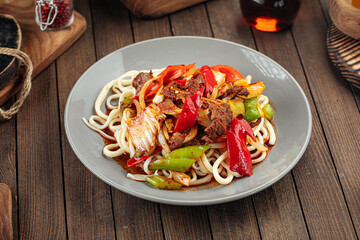 Asian uyghur dish guiru lagman noodles on a wooden background