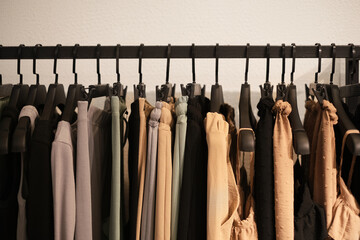 fashionable clothes made from natural fabrics on hangers in the store. new minimal collection of clothes in the boutique.