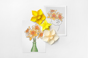 Origami narcissus flowers and greeting cards on white background