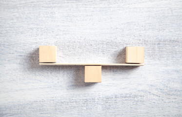 Balance scales made in from wooden cubes.