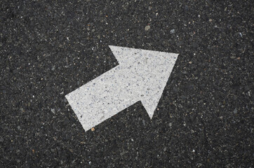 Asphalt with an arrow sign pointing to the upper right. Tarmac road with an arrow pointing to the upper right