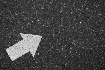 Asphalt with an arrow sign pointing to the upper right. Tarmac road with an arrow pointing to the upper right
