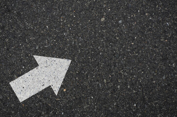 Asphalt with an arrow sign pointing to the upper right. Tarmac road with an arrow pointing to the...