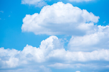 Naklejka na ściany i meble Blue sky background with big white clouds in summer.