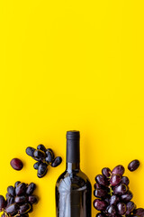 Red wine bottle with grapes. Top view
