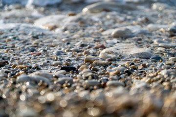 Close up view of beach pebbles in dusk. Pebble stones on sea shore