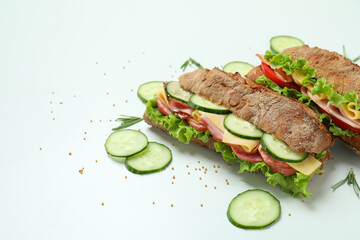 Ciabatta sandwiches and ingredients on white background