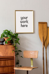 Stylish and vintage interior design of living room with wooden retro commode, plants, ships, paddle, map and elegant personal accessories. Mock up poster frame on the wall. Template. Home decor.