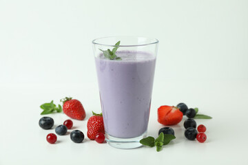 Glass of smoothie and ingredients on white background