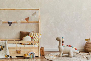 Stylish composition of cozy scandinavian child's room interior with wooden bed, pillows, plush dinosaur, wooden toys and textile decorations. Neutral wall, carpet on the floor. Copy space. Template. - obrazy, fototapety, plakaty