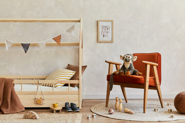 Fototapeta na wymiar Stylish composition of cozy scandinavian child's room interior with wooden bed, red armchair, plush and wooden toys and hanging decorations. Neutral wall, carpet on the floor. Copy space. Template.