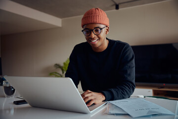 African American male working from home using laptop. Happy African American male working from home. High quality photo 