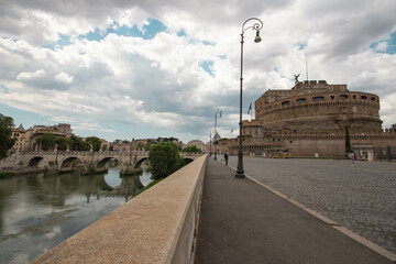 St. Angelo Bridge and Castel Sant'Angelo on cloudy day in summer 2021 Italy.The popular street...