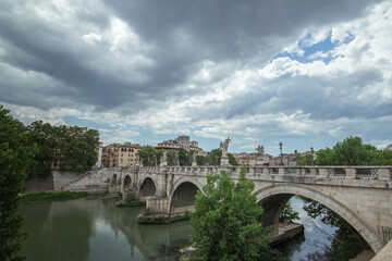 Obraz premium Panoramic of St. Angelo Bridge on cloudy day in summer 2021 Italy.Pedestrian bridge, built in 134 A.D., with travertine marble fascias and spanning the River Tiber.