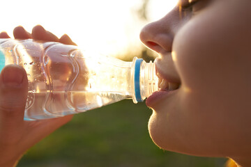 pretty woman drinking water from a bottle summer thirst