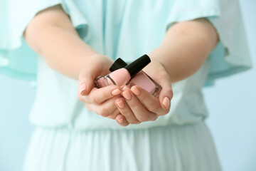 Obraz na płótnie Canvas Woman with beautiful manicure and nail polish on color background, closeup