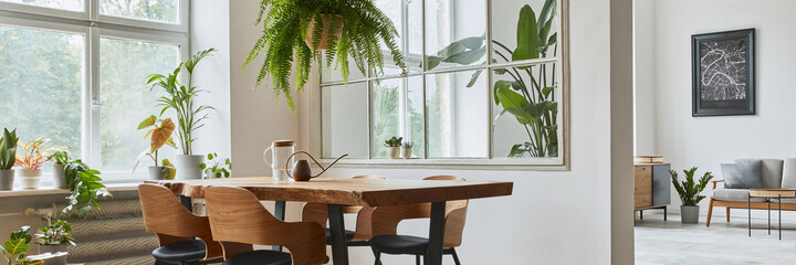 Stylish and botany interior of dining room with design craft wooden table, chairs, furniture, a lof...