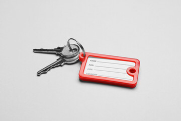 Keys with plastic tag on grey background