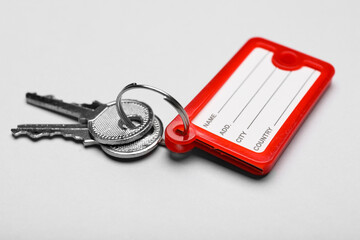 Keys with plastic tag on grey background
