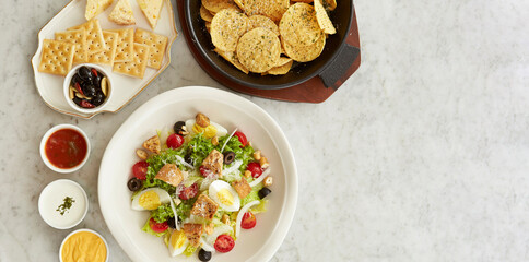 Vegetable salad with nacho chips and sauces