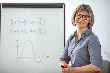Online Education. Female Math teacher having video conference chat with students and class group,...