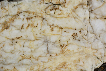 Natural light stone with orange veins, texture close-up