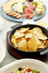 Nachos chips and salad on the table