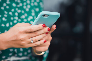 young woman using smartphone in hand on the street