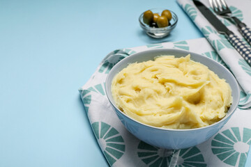 Composition with tasty mashed potatoes on color background