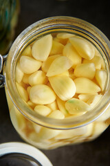 Garlic pickled in vinegar in a glass container