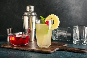 Glass of delicious mai tai cocktail on dark background