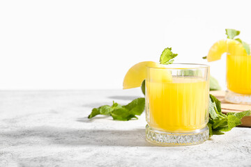 Glasses of delicious mai tai cocktail on light background