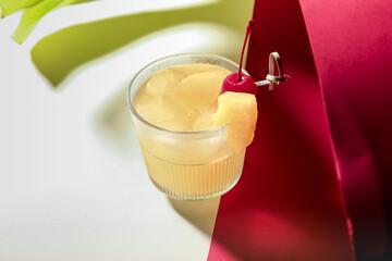 Glass of delicious mai tai cocktail on color background
