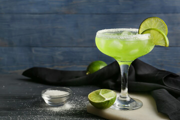 Glass with tasty daiquiri cocktail on color wooden background