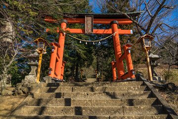 Red Japanese Torii Entrance Gate to Shinto Shrine and Chureito Pagoda in Arakurayama Sengen Park, Japan.
Japanese text reads: "One of Three Entrances"