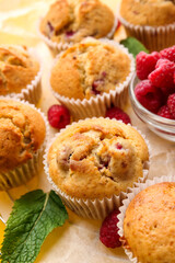 Tasty raspberry muffins on table, closeup