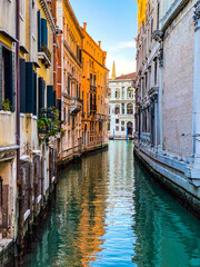 Fototapeta na wymiar Small canal in Venice, Italy, with balcony, and, blue sky reflexion on water, no boat, no people
